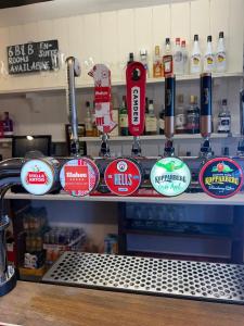 a counter with a bunch of stickers on it at The BILLINGFORD HORSESHOES in Scole