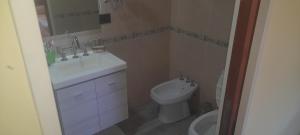 a bathroom with a sink and a toilet at Quinta la ponderosa in Brandsen