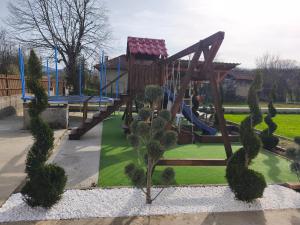 a playground with a slide in a park at Къща за гости Алтея in Sarovtsi