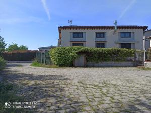 a white house with a fence in front of it at Fienile Paradiso Home Tuscany in Campi Bisenzio