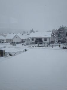 a group of buildings with snow on the roofs at Haus Orleander in Rehgraben