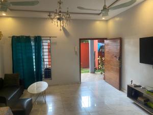 a living room with a couch and a table at Home RÉSIDENCE OUIDAH in Ouidah