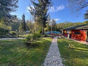 a gravel path in front of a cabin at Tinaraft camp in Radovljica