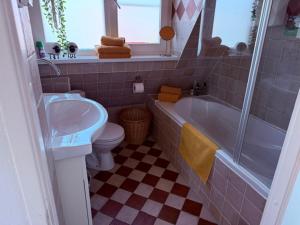 a bathroom with a sink and a tub and a toilet at B&B Zonnedael in Oosterend +24 photos