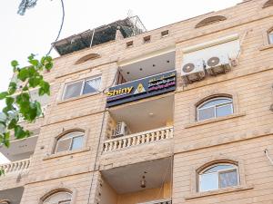 a building with a sign on the side of it at Shiny Pyramids Boutique Hotel in Cairo