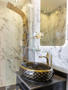 a bathroom with a sink and a mirror at Shiny Pyramids Boutique Hotel in Cairo +40 photos