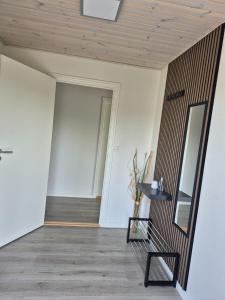 a hallway with a bench and a mirror at Annes Hus in Rødekro