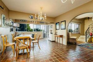 a kitchen and living room with a table and chairs at FlowithLin Guesthouse in Durban