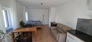 a living room with a couch and a table at Apartments Leipziger Neuseenland in Markkleeberg