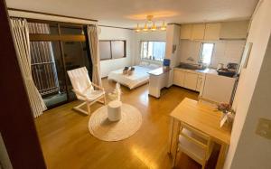 a room with a kitchen and a living room at 眠りの癒201 I Cozy Apt, 3min Beach, Bus, Train, Onsen, Izakaya, WiFi in Beppu