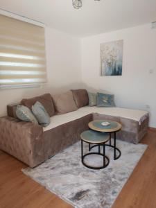 a living room with a couch and a table at Kuća za odmor "Moja idila" in Vrnjačka Banja