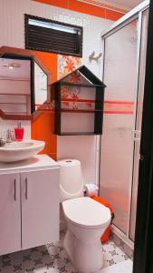 a bathroom with a toilet and a sink at Posada Martha Tolima in Salento +105 photos