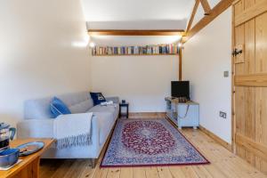 a living room with a couch and a tv at 1 Bed in Dorstone oc-c31765 in Dorstone