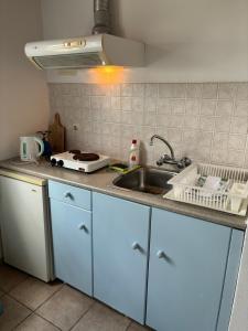 a kitchen with a sink and a counter top at Faros Rooms Armenistis in Armenistis +11 photos