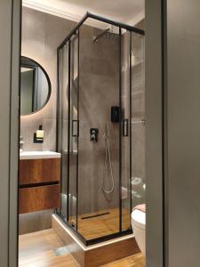 a bathroom with a shower with a toilet and a sink at NK Loft in Alexandroupoli