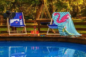 two chairs sitting next to a swimming pool at Agroturystyka Husinka pl in Husinka