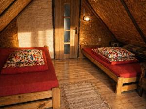 a bedroom with two beds in a attic at Agroturystyka Husinka pl in Husinka +13 photos