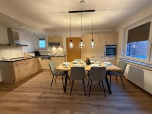 a kitchen with a dining room table and chairs at FeWo Bispingen in Bispingen