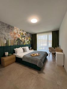 a bedroom with a bed and a painting on the wall at ATEA Apartments in Kavarna +213 photos
