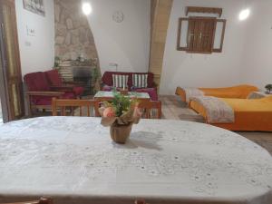 a table with a vase of flowers on top of it at Vocation Rest House in Anogyra in Anoyira