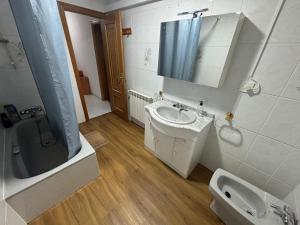 a bathroom with a sink and a tub and a toilet at Casa cerca de Las Medulas in Puente de Domingo Flórez