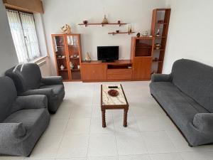 a living room with two couches and a coffee table at Casa cerca de Las Medulas in Puente de Domingo Flórez