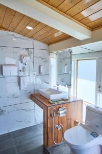 a bathroom with a sink and a toilet at Ruscello in Pālampur +51 photos