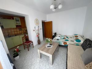 a living room with a bed and a kitchen at Summerland Lukovë in Sarandë