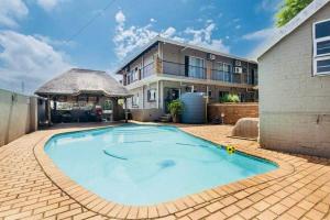a large swimming pool in front of a house at FlowithLin Guesthouse in Durban