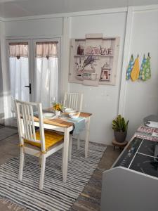 a dining room with a table and two chairs at Atico Dolce Natura in Arrecife +8 photos