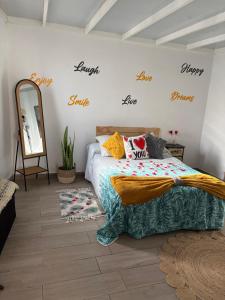 a bedroom with a bed and a mirror at Atico Dolce Natura in Arrecife