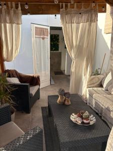 a living room with a table and a couch at Atico Dolce Natura in Arrecife