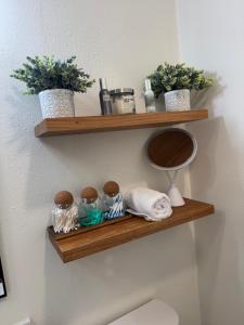 a bathroom with wooden shelves on the wall at Chic East LA Retreat 2 bedroom-sleeps 6-Near DTLA-Car Rental Service on Property in East Los Angeles +77 photos