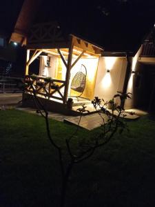 a house with a lit up porch at night at Kuća za odmor "Moja idila" in Vrnjačka Banja