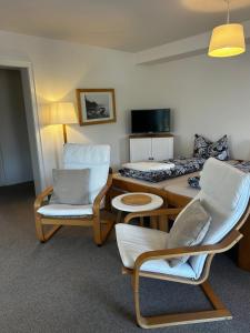 a living room with a table and chairs and a couch at Ferienhaus Rotzinger in Hinterzarten