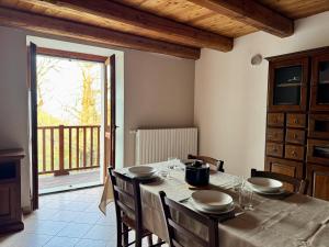 a dining room with a table and a balcony at Maison Champriond in Rif +13 photos