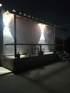 a stage with two lights and chairs at night at Holiday house in Laknas