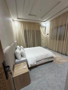 a hotel room with a bed and a table at Villa Golden Sun in El Jemʼa Ghemat