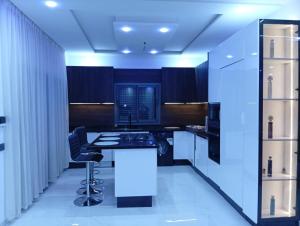 a kitchen with black cabinets and a white counter top at Villa Golden Sun in El Jemʼa Ghemat