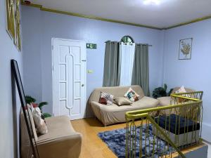 a living room with a couch and a chair at AJM Iligan Homestay in Saray