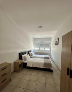 a white bedroom with a bed and a window at B&B bellinzona gino in Bellinzona