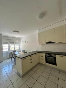 a kitchen with white cabinets and a black counter top at B&B bellinzona gino in Bellinzona