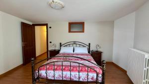 a bedroom with a bed with a red blanket at Maison Champriond in Rif