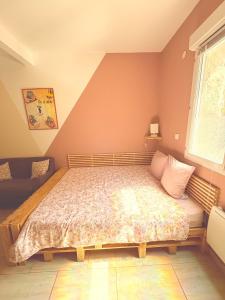 a bedroom with a bed and a window at La petite Escapade in Calais