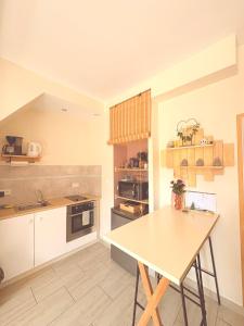 a kitchen with a table and a counter top at La petite Escapade in Calais