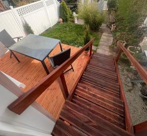 a wooden deck with a table on top of it at Fichtelrooms in Fichtelberg