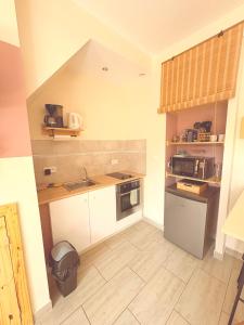 a small kitchen with a sink and a stove at La petite Escapade in Calais +18 photos