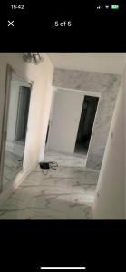 an empty room with a mirror and a tile floor at Apartament ICAS 2 in Dej