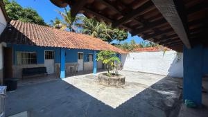 a house with a tree in a courtyard at Casa com Piscina Privativa e Churrasqueira in Araruama