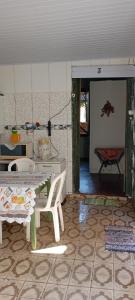 a room with a table and chairs and a room with a door at Casarão D'Ávila aluguel por temporada in Goiás